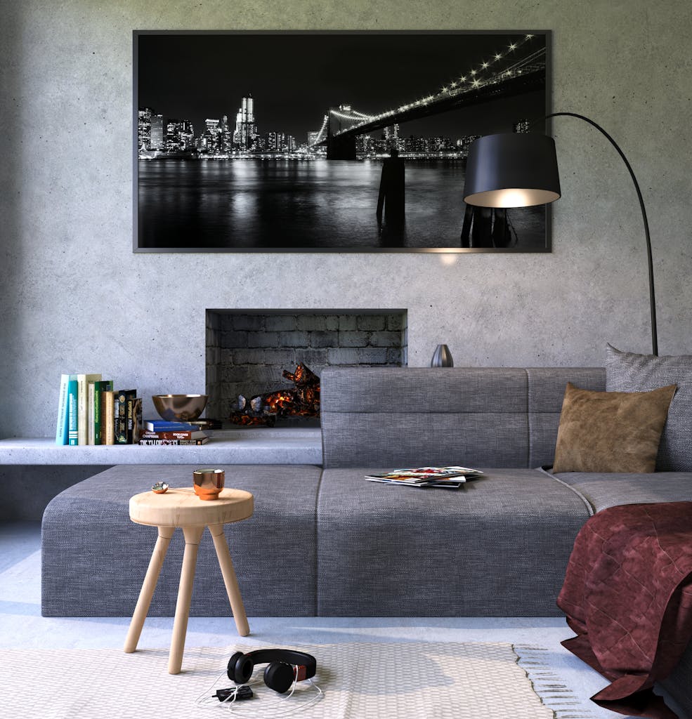 Wohnformen – Nachhaltiges & soziales Wohnen mit Symbiovita (e.V.) 4 Wohnformen – Nachhaltiges & soziales Wohnen mit Symbiovita (e.V.) Modern gray living room featuring a fireplace and cityscape artwork, creating a cozy ambiance.